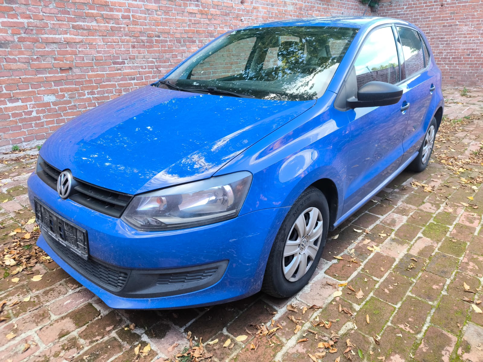 Blauer VW Polo Kompaktwagen vor Backsteinmauer in Albstadt verkauft und jetzt dort einfach Auto verkaufen