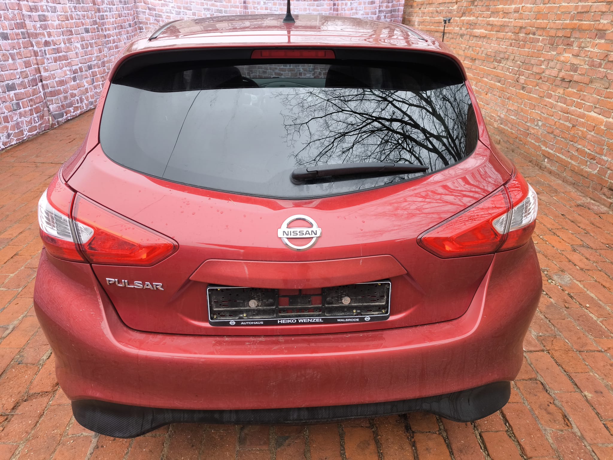 Roter Nissan Pulsar von hinten in Hofansicht als bereits verkaufter Gebrauchtwagen in Stade verkaufen